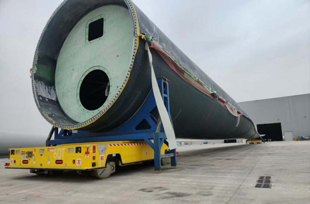 how dual vehicle agvs solve the mega challenge of 100 meter wind turbine blade transport 1