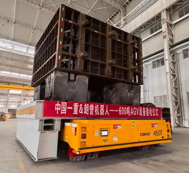 Heavy-duty AGV transporting 600-ton industrial mold in high-temperature manufacturing workshop with rugged chassis and autonomous navigation system by Lonyu Robotics