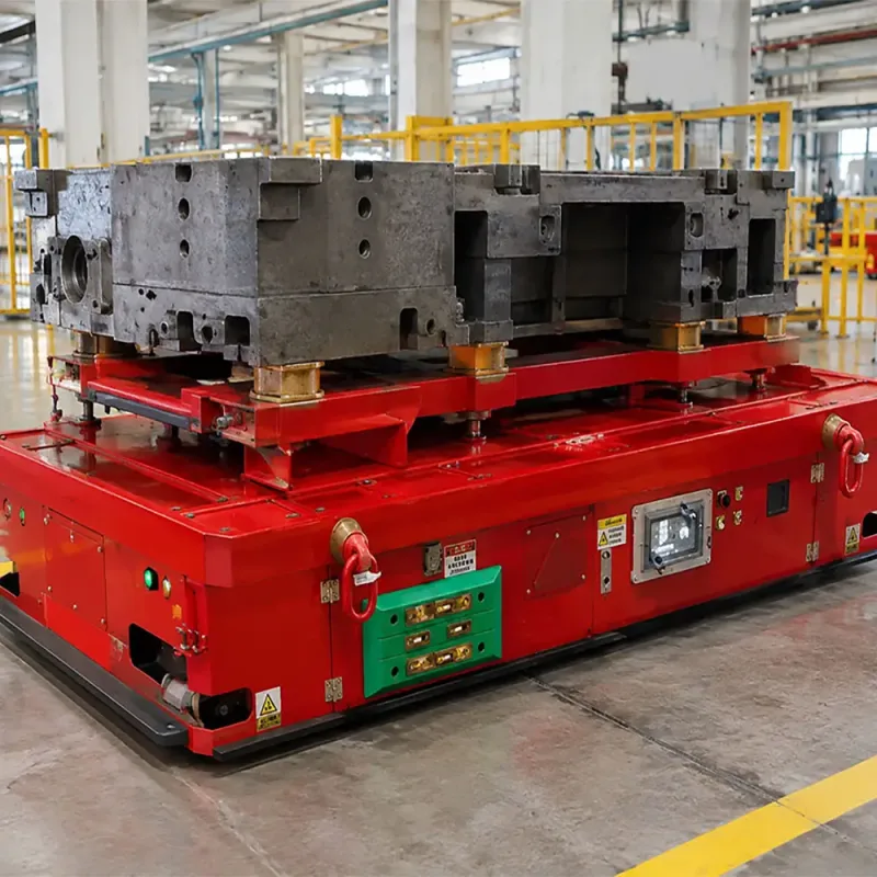 Automatic mold transfer system AGV carrying a heavy industrial die in a manufacturing plant.